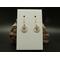Machine embroidered tiny sand dollar earrings. Tan in color with blue and brown accents. Gold hypoallergenic hooks.